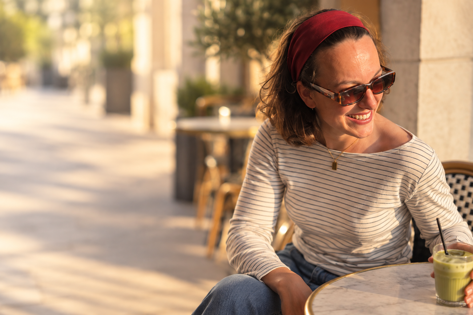 Grace smiling at a sunny café